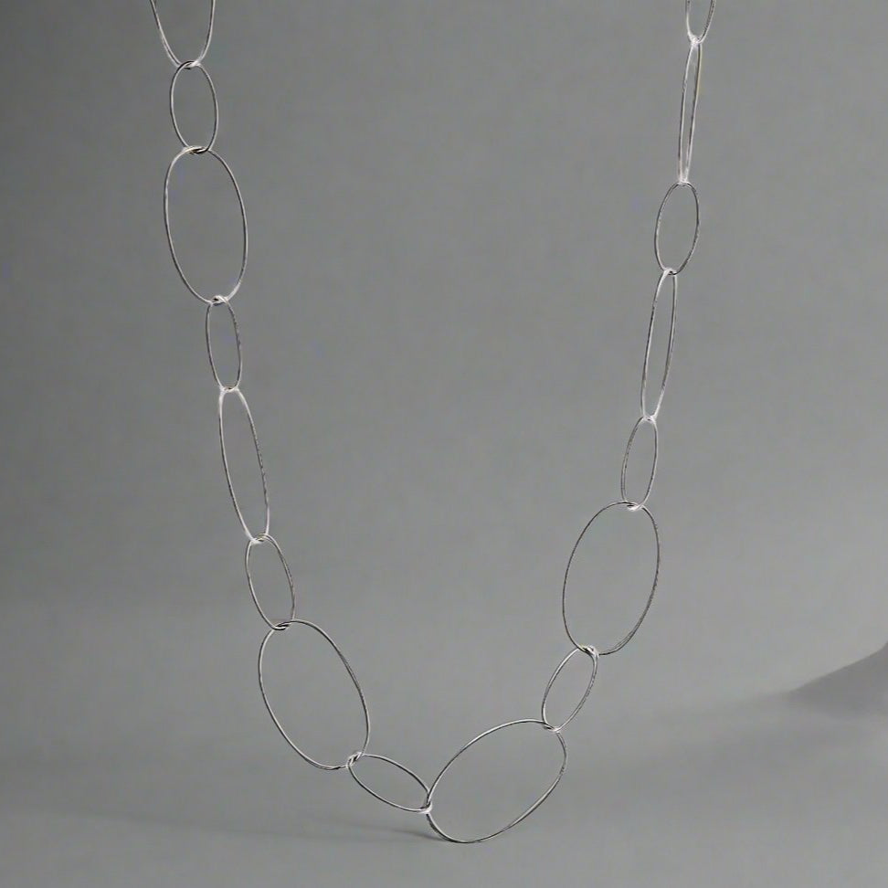 Silver necklace made of hoops with a toggle clasp.