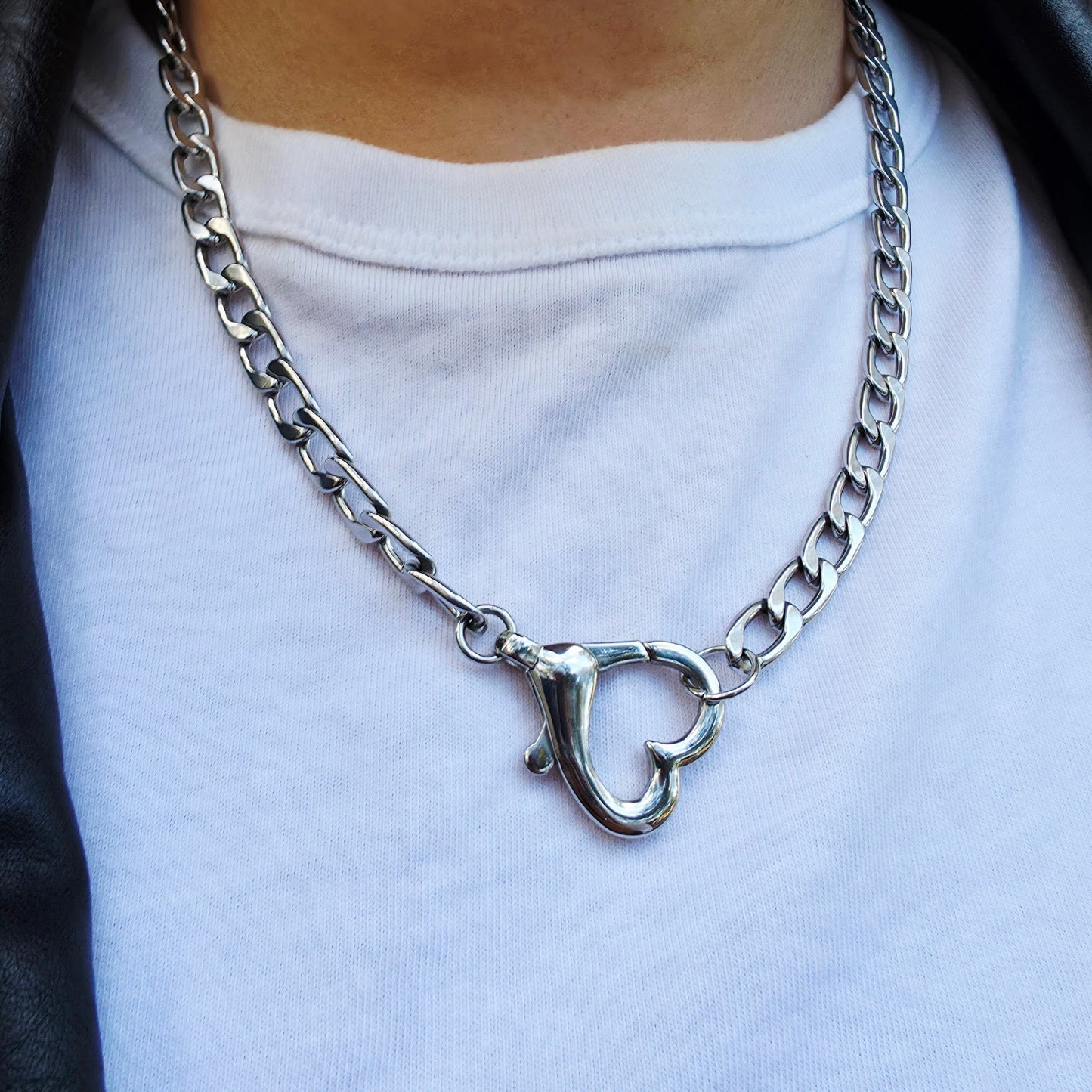 Silver chain necklace with a unique clasp on a white shirt