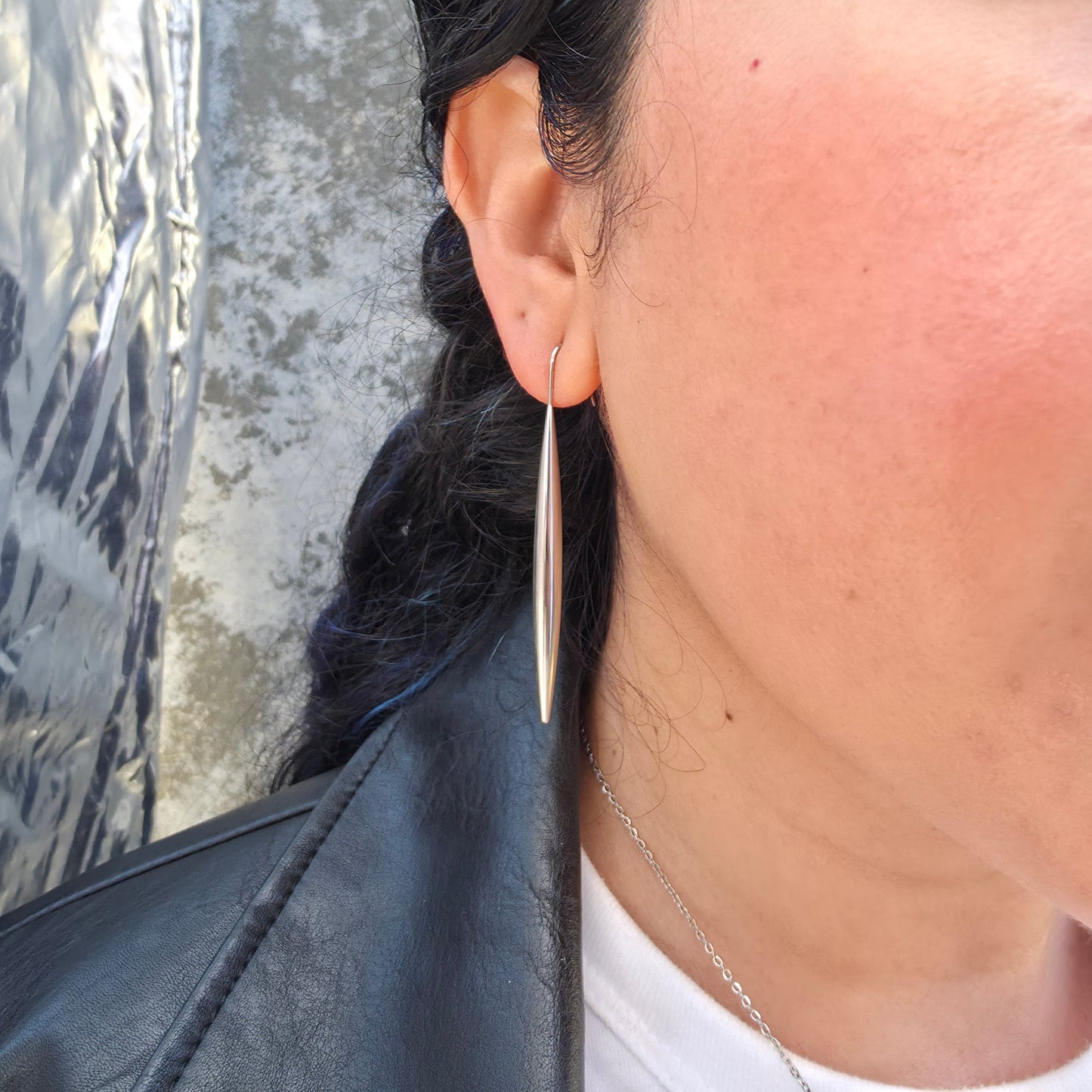 Close-up of the model wearing the Stiletto Earring.