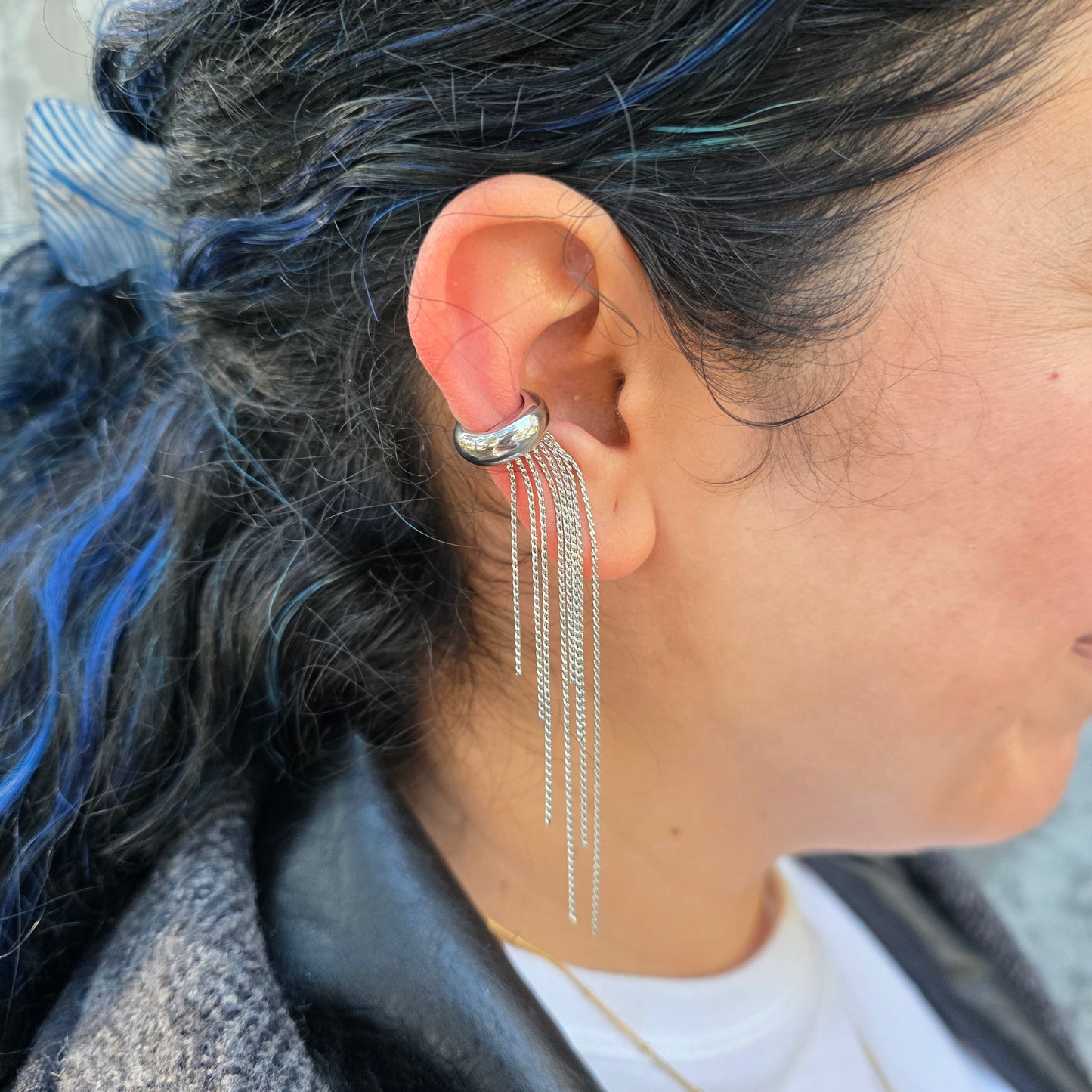 Close-up of an ear with a silver earring.