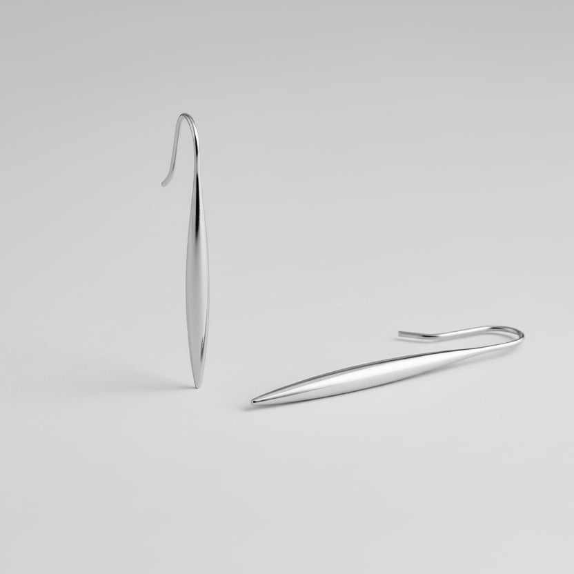 Silver earring on a light gray background