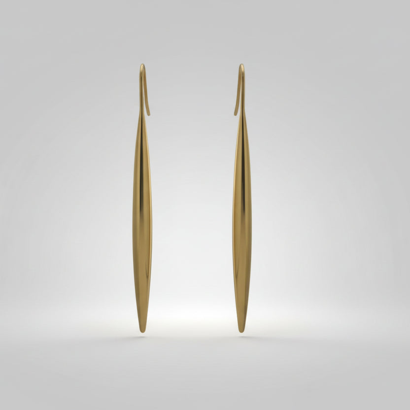 Pair of gold earrings on a light gray background