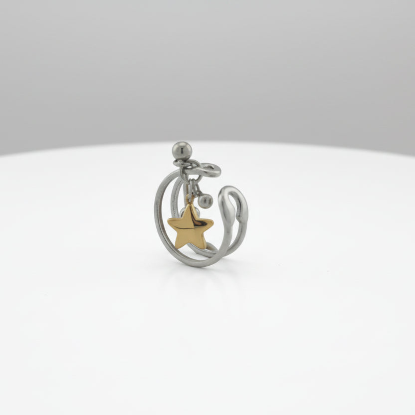 Silver and gold star-shaped pendant on a ring on a white background