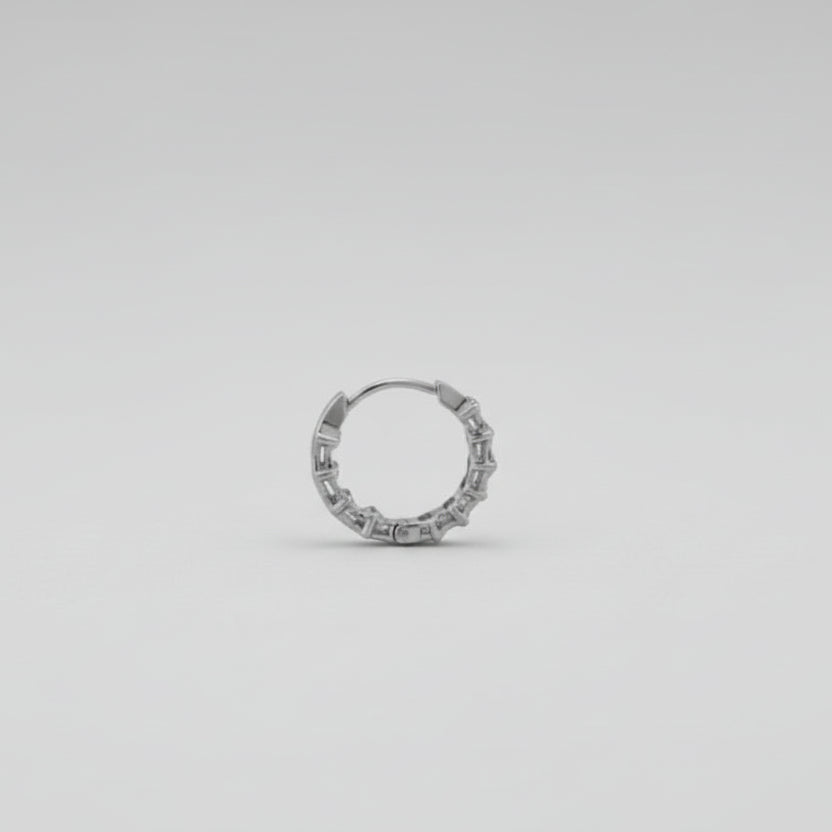 Silver ring on a reflective gray surface