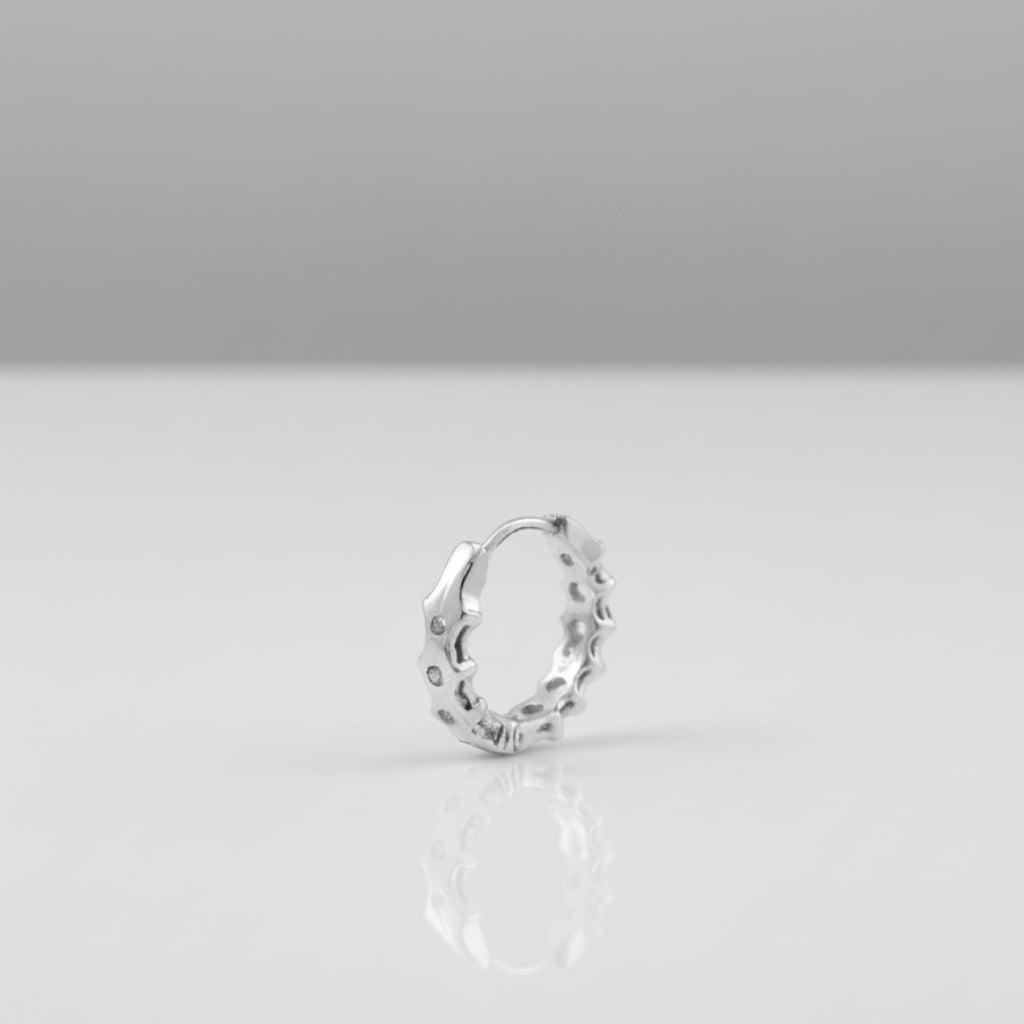 Silver ring on a gray surface