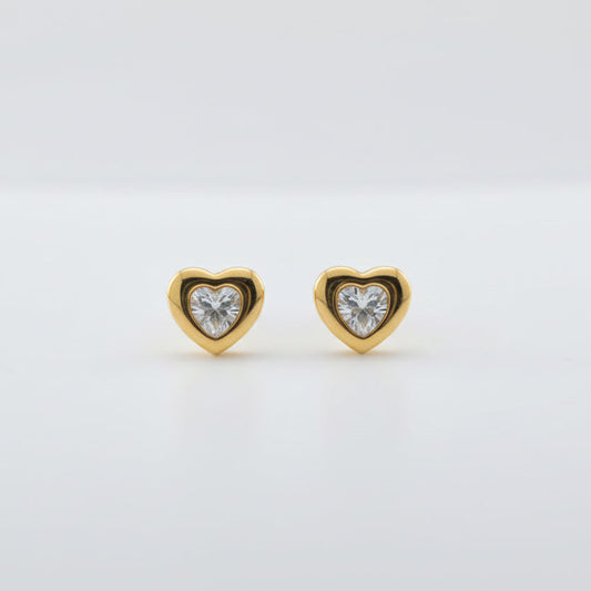 Gold heart-shaped earring with a clear gemstone on a white background