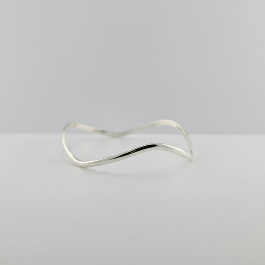 Silver bracelet on a gray background