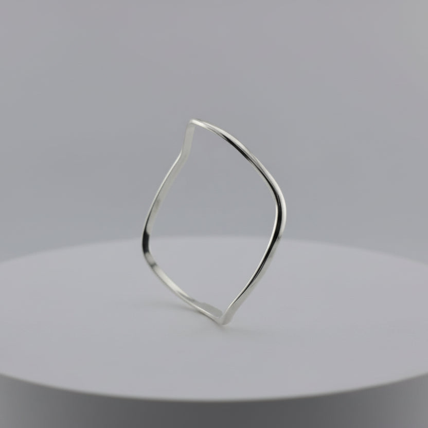 Silver Bracelet with a geometric design on a gray background
