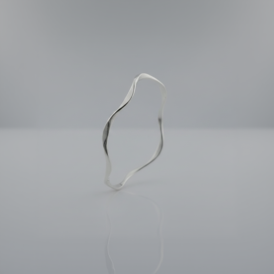 Silver bracelet on a light gray background