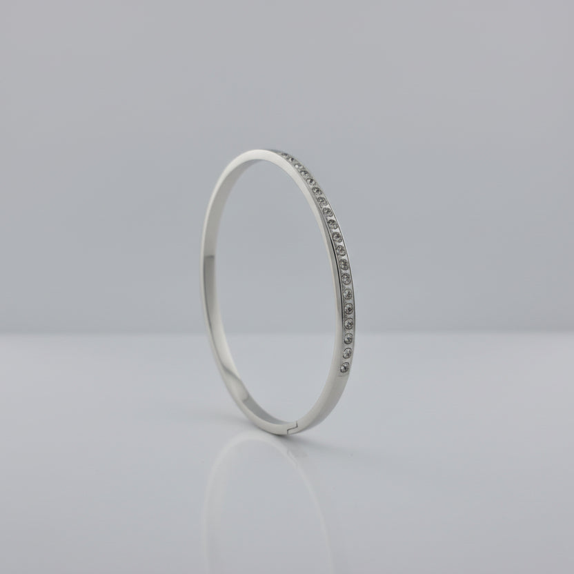 Silver Bracelet with small Zirconia stones on a light gray background