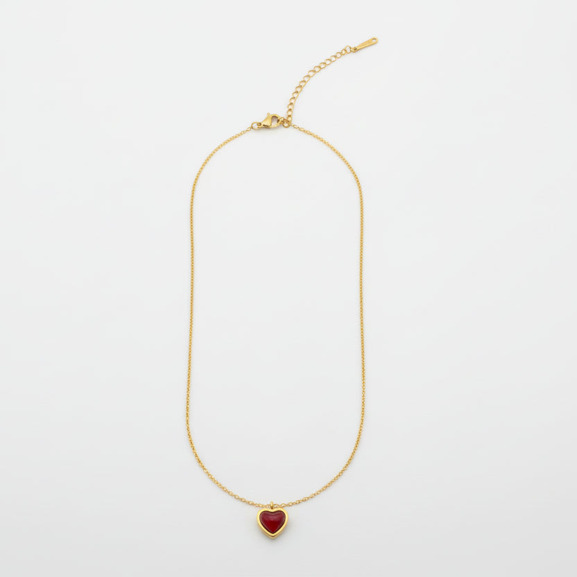Gold necklace on a light gray background
