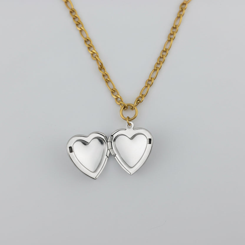 Heart-shaped locket necklace on a light gray background