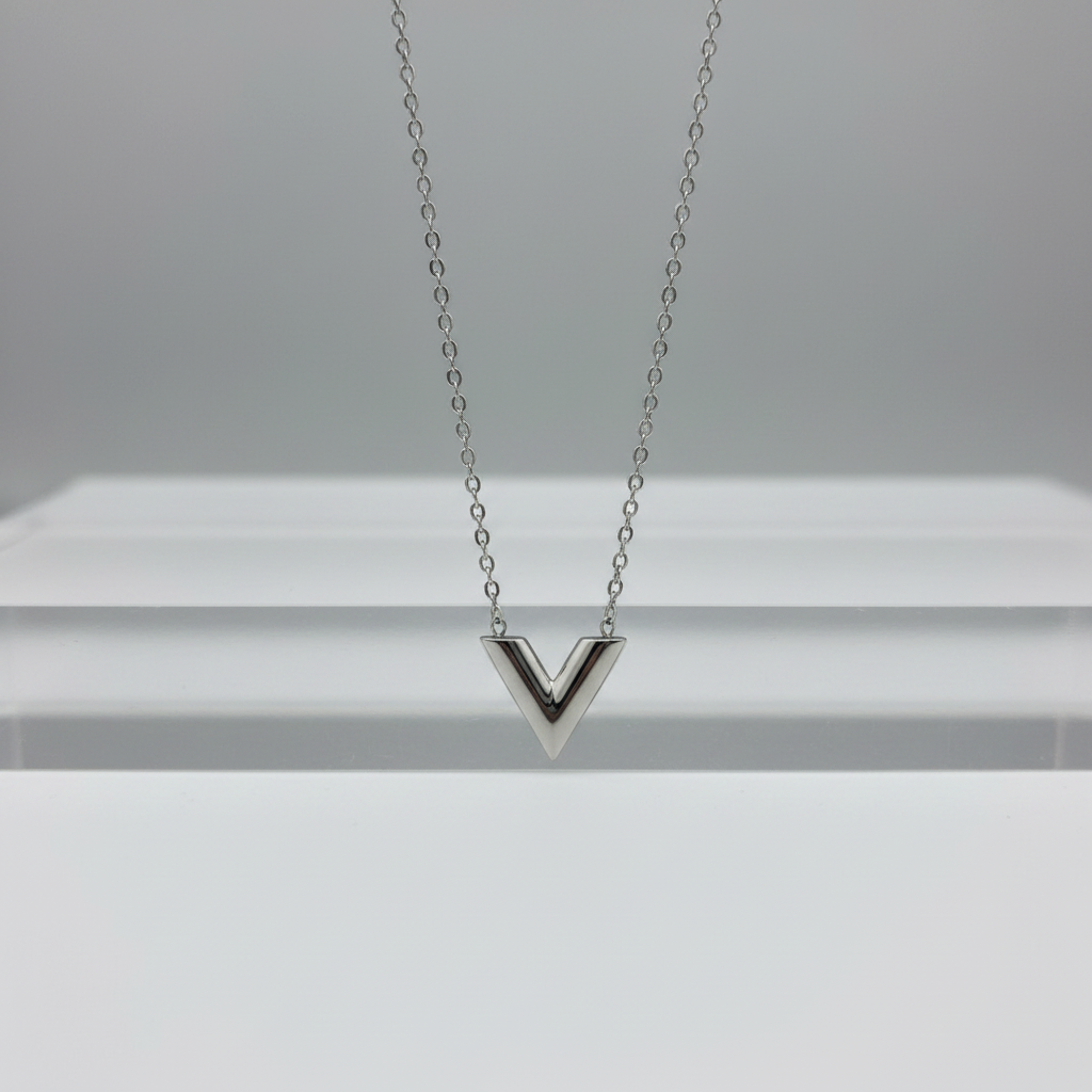 Silver necklace with a V-shaped pendant on a white background