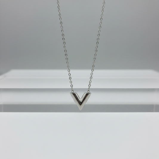 Silver necklace with a V-shaped pendant on a white background