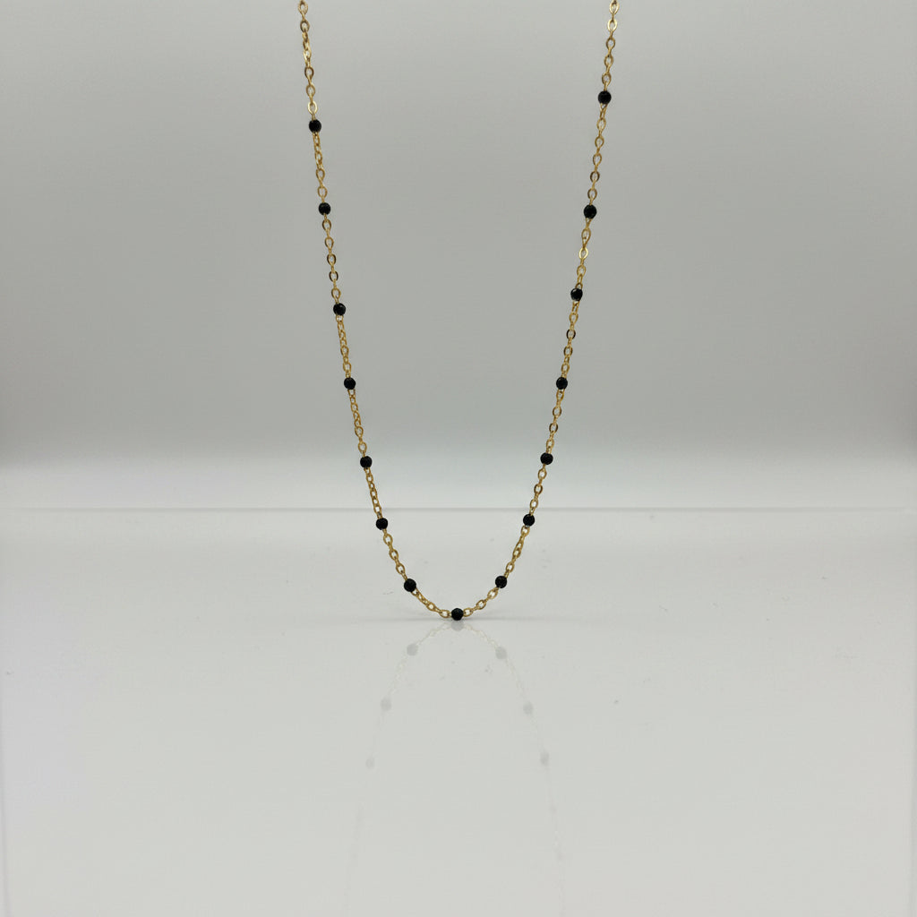 Close-up of a Necklace with black beads on a light gray background