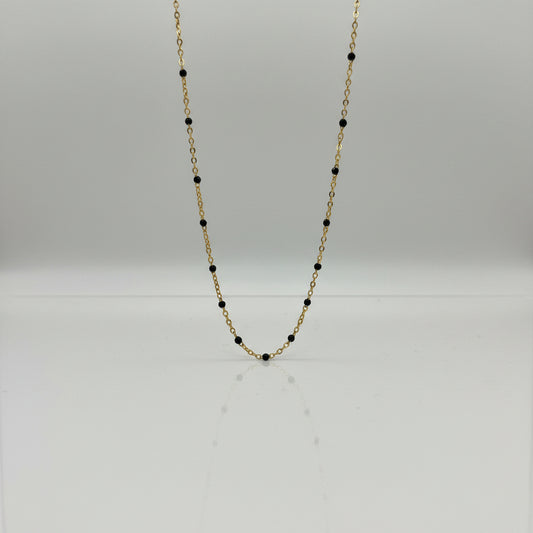Close-up of a Necklace with black beads on a light gray background
