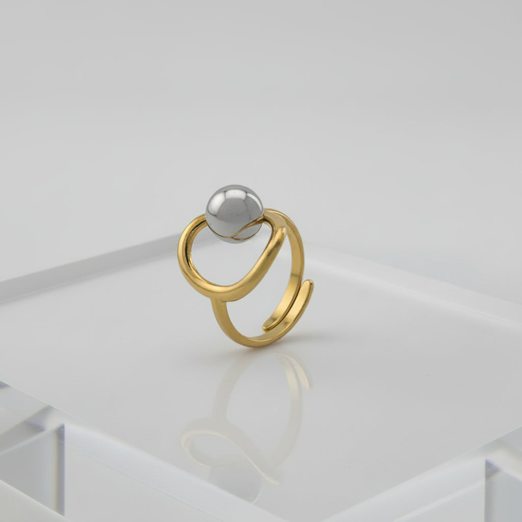 Gold and silver ring on a gray background