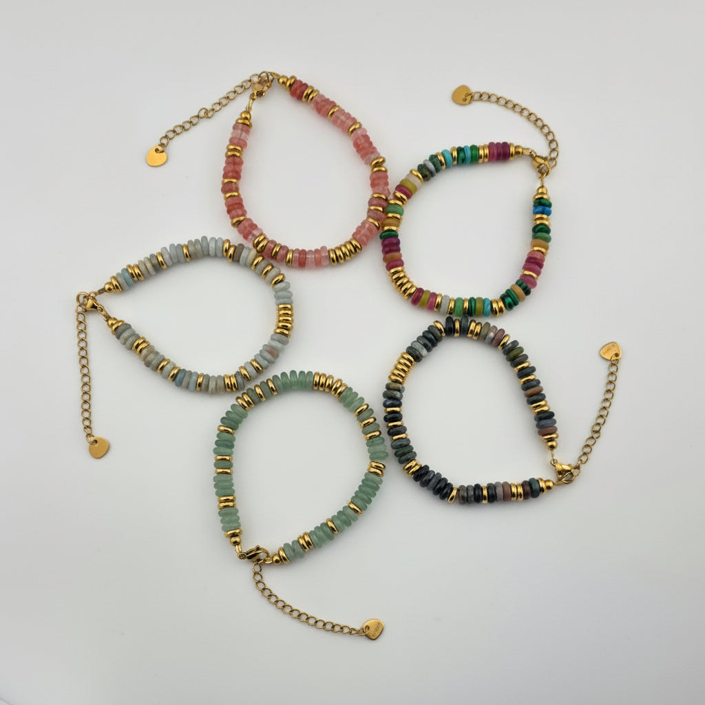 Set of beaded bracelets with gold accents on a light gray background